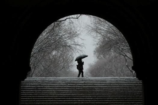 A pedestrian walks through Central Park during a snowstorm in New York, March 7, 2018.