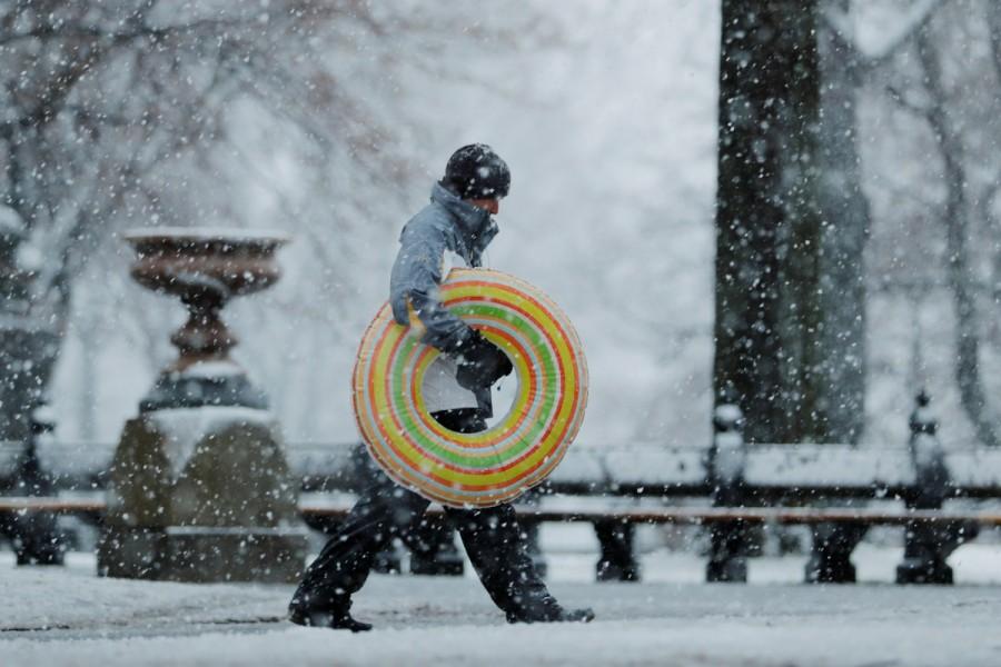 A pedestrian walks through Central Park during a snowstorm in New York. Winter storm,winter storm Northeast,Northeast,New York,New York snowfall