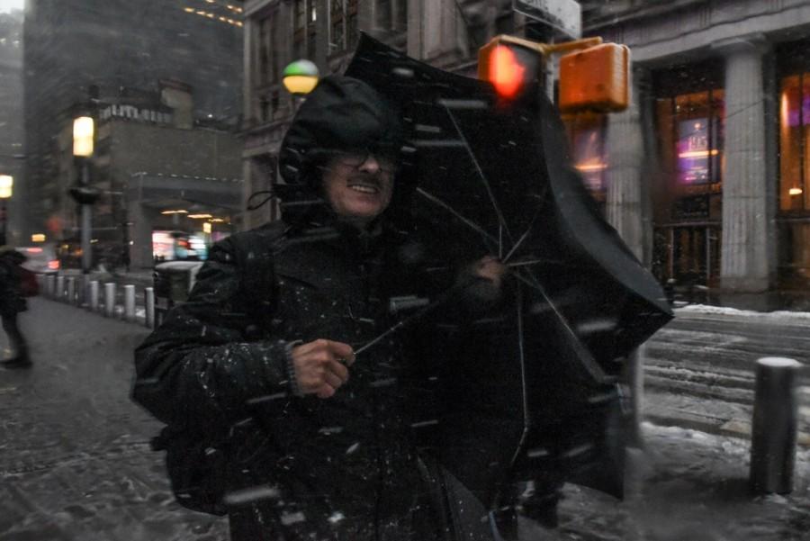 A man struggles with his umbrella during a nor'easter storm in New York City. Winter storm,winter storm Northeast,Northeast,New York,New York snowfall