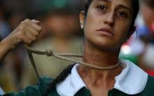 A woman shows a noose around her neck as she takes part in a rally in Santiago, Chile.