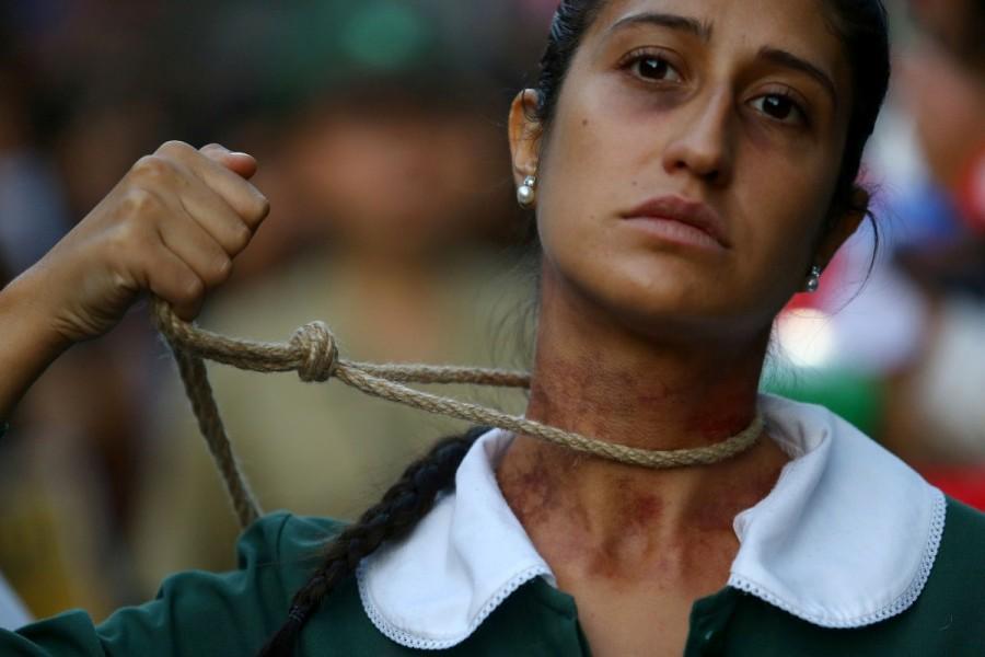 A woman shows a noose around her neck as she takes part in a rally in Santiago, Chile. International Women's Day 2018,International Women's Day 2018 celebration,Women's day celebration,Women's day celebration pics,Women's day celebration images