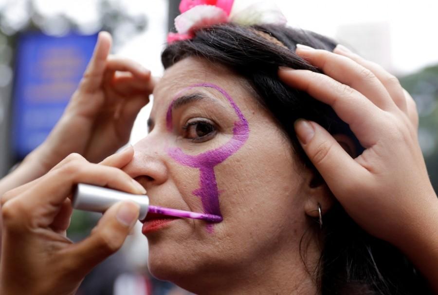 A woman has her face painted before attending a march in Sao Paulo, Brazil. International Women's Day 2018,International Women's Day 2018 celebration,Women's day celebration,Women's day celebration pics,Women's day celebration images