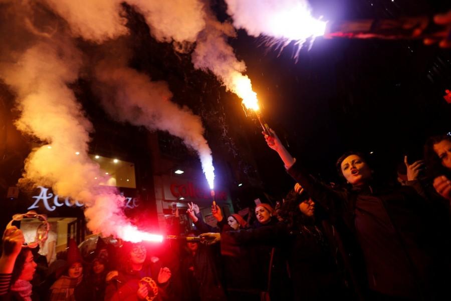 Activists light flares as they march at the main shopping and pedestrian street of Istiklal during a rally on the International Women's Day in Istanbul, Turkey March 8, 2018. International Women's Day 2018,International Women's Day 2018 celebration,Women's day celebration,Women's day celebration pics,Women's day celebration images