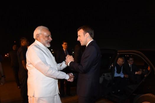 Modi breaks protocol, receives French President at airport.