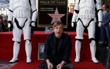 Mark Hamill poses on his star with Stormtroopers.