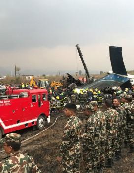 Wreckage of an airplane is pictured as rescue workers operate at Kathmandu airport, Nepal.