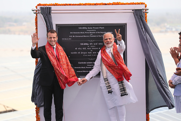 Indian Prime Minister Narendra Modi (R) and French President Emmanuel Macron gesture at the opening of a solar power plant in Mirzapur on March 12, 2018. French President Emmanuel Macron,Emmanuel Macron,Emmanuel Macron in India,Emmanuel Macron best moments,Emmanuel Macron best moments in India