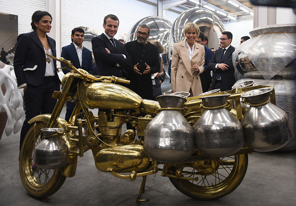 French President Emmanuel Macron (3rdL) and his wife Brigitte Macron (2ndR) listen to Indian artist Subodh Gupta (C) during a visit to his showroom on March 11, 2018. French President Emmanuel Macron,Emmanuel Macron,Emmanuel Macron in India,Emmanuel Macron best moments,Emmanuel Macron best moments in India