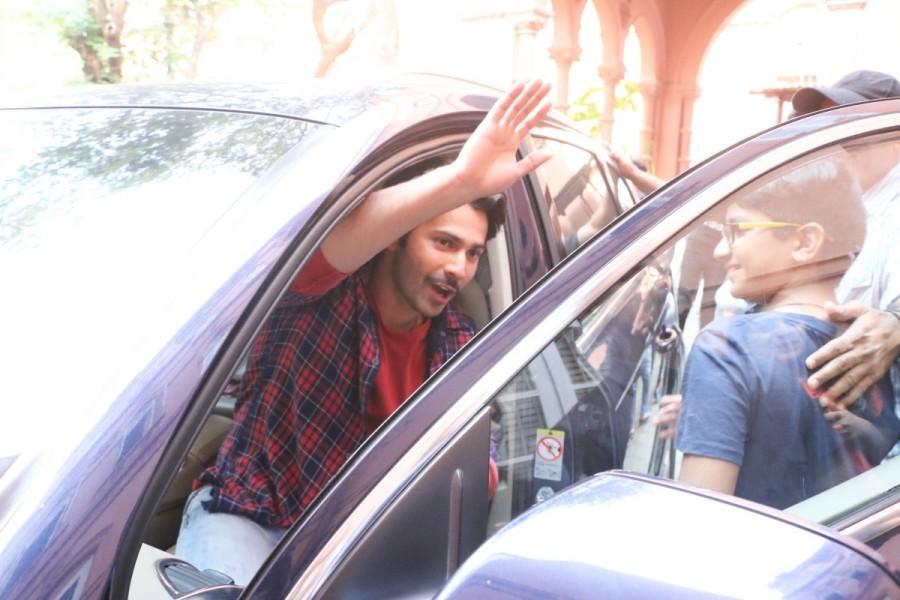 Varun Dhawan waves to the photographers as he enters the place. Varun Dhawan and Banita Sandhu,Varun Dhawan,Banita Sandhu,October,October promotion,October movie promotion,October promotion pics,October promotion images