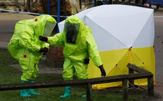The forensic tent, covering the bench where Sergei Skripal and his daughter Yulia were found, is repositioned by officials in protective suits in the centre of Salisbury, Britain.