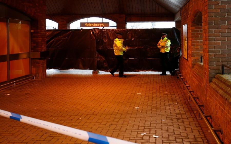 Police officers work behind a cordon at a supermarket near the bench where former Russian intelligence officer Sergei Skripal and his daughter Yulia were found poisoned, in Salisbury, Britain. Russian double agent,Russian agent,Sergei Skripal,Sergei Skripal and his daughter,former Russian double agent