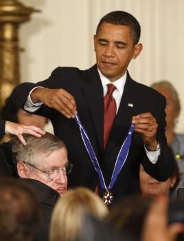 U.S. President Barack Obama presents the Medal of Freedom to scientist Stephen Hawking during a ceremony in the East Room of the White House in Washington, August 12, 2009.