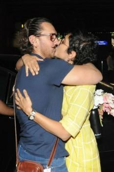 Birthday boy Aamir Khan locks lips with wife Kiran Rao at Mumbai airport.