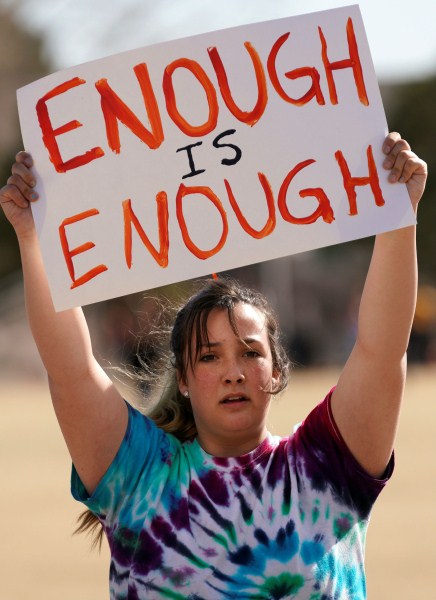 Columbine High School student Leah Zunder holds a sign during a National School Walkout in Littleton, Colorado. Florida school shooting,Marjory Stoneman Douglas High School shooting,National School Walkout,protest against gun violence,U.S. Students Protest Gun Violence