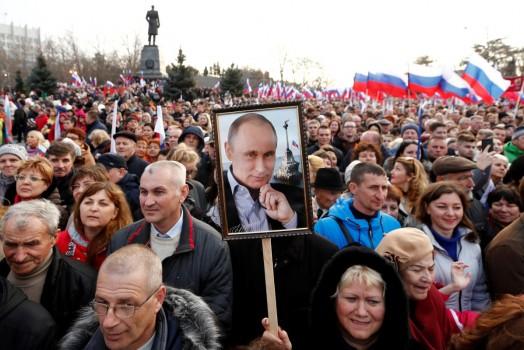 People attend a rally marking the fourth anniversary of Russia's annexation of Ukraine's Crimea region in the Black Sea port of Sevastopol, Crimea, March 14, 2018. As part of his campaign for re-election, President Vladimir Putin visited Crimea and addressed a crowd of cheering supporters with a speech that emphasised Russia's claim to the territory.