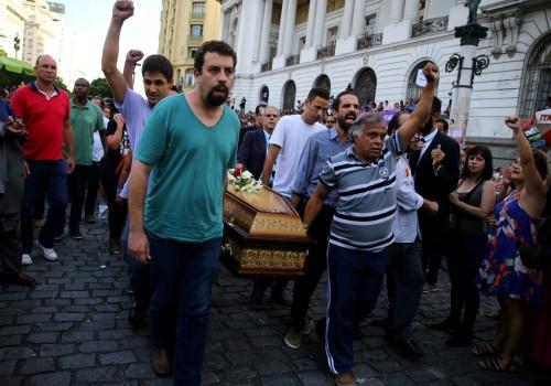 Brazil's presidential pre-candidate of the Socialism and Freedom Party (PSOL) Guilherme Boulos helps to carry the coffin of councilwoman Marielle Franco outside the Legislative Assembly in Rio de Janeiro.