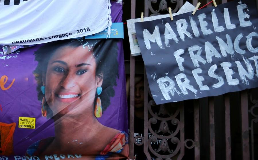 A mourner reacts next to a picture of the Rio de Janeiro city councillor Marielle Franco during a demonstration ahead of the wake outside the city council chamber in Rio de Janeiro. Brazilian activist politician,Brazilian politician,murder of Marielle,Marielle Franco,Rio de Janeiro