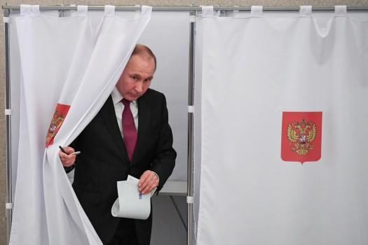 Russian President and presidential candidate Vladimir Putin is seen at a polling station during the presidential election in Moscow, Russia March 18, 2018.
