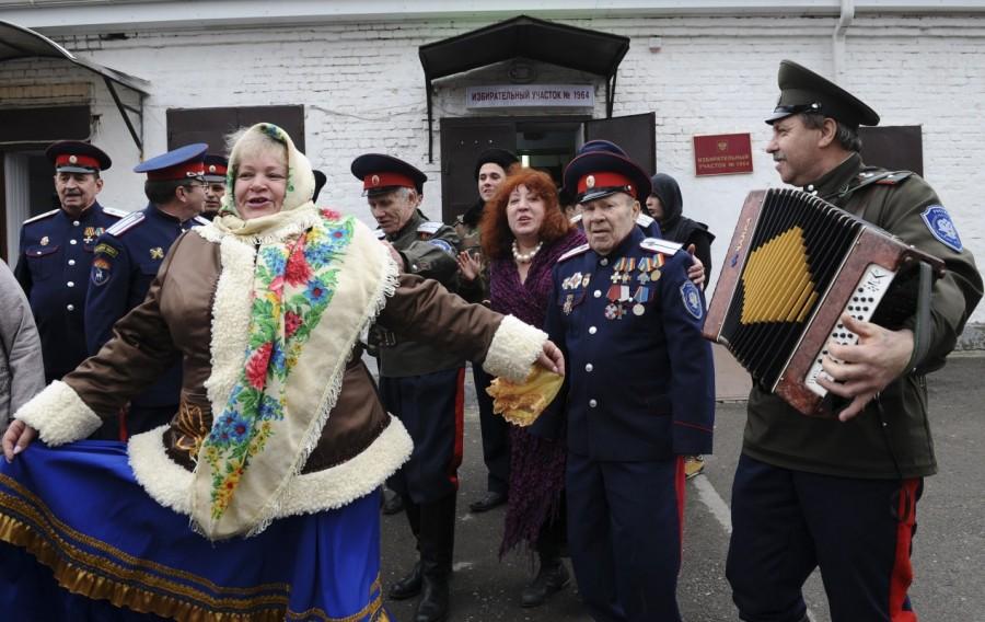 Members of a local Cossack community dance outside a polling station in Rostov-on-Don. Vladimir Putin,Russian President Vladimir Putin,president vladimir putin,Vladimir Putin wins,Vladimir Putin re-election,Vladimir Putin pics,Vladimir Putin images