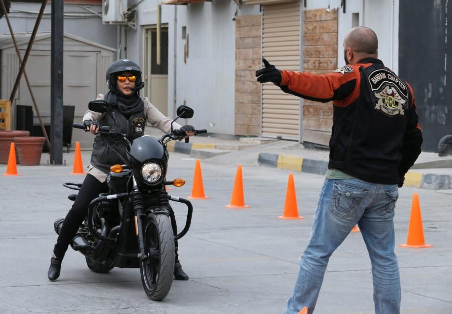 Maryam Ahmed Al-Moalem rides a bike during her lessons in Manama, Bahrain. "Things are changing in Middle East and I want to thank all the heads of states, kings and princes who just changed the rules, made big moves and for having more sisters joining the group," said Claude Abry, the general manager of motorcycle group Harley Davidson in Saudi Arabia and member of the Bahrain Harley Owners group. Maryam Ahmed Al-Moalem,Saudi woman,Saudi woman learns motorcycle,woman learns motorcycle,Bahrain