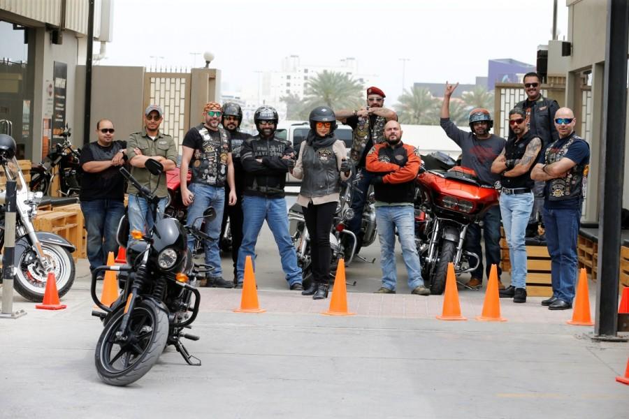 Maryam Ahmed Al-Moalem (C) poses for a group photo with Bahrain and Saudi riders during her lessons in Manama, Bahrain. Maryam Ahmed Al-Moalem,Saudi woman,Saudi woman learns motorcycle,woman learns motorcycle,Bahrain