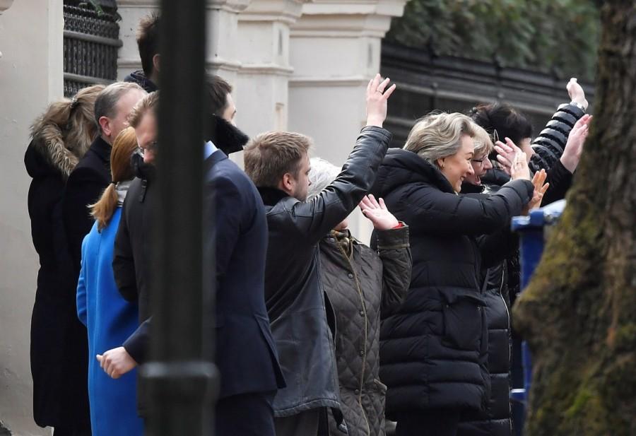 Embassy staff wave as colleagues and children board buses outside Russia's Embassy in London. Russian embassy,Russian embassy in London,Buses leave Russian embassy,London expelled,Moscow