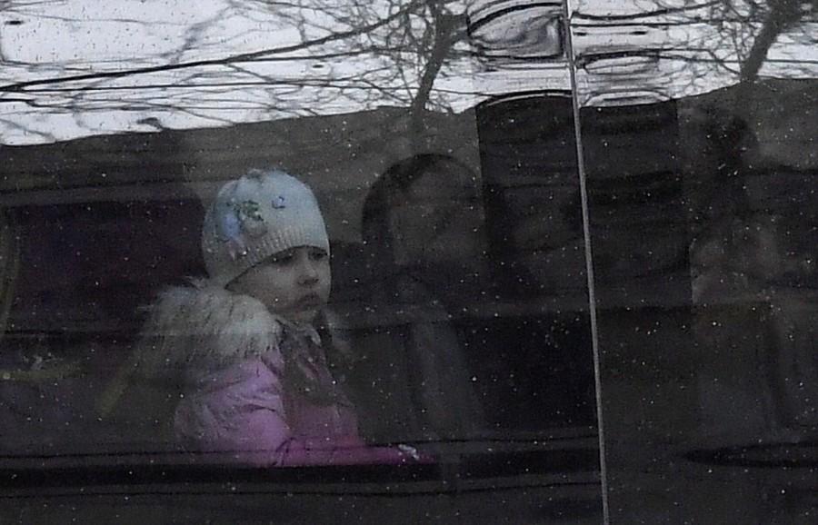 A child sits on a bus with diplomatic number plates as embassy staff and children arrive at Russia's Embassy in London. Russian embassy,Russian embassy in London,Buses leave Russian embassy,London expelled,Moscow