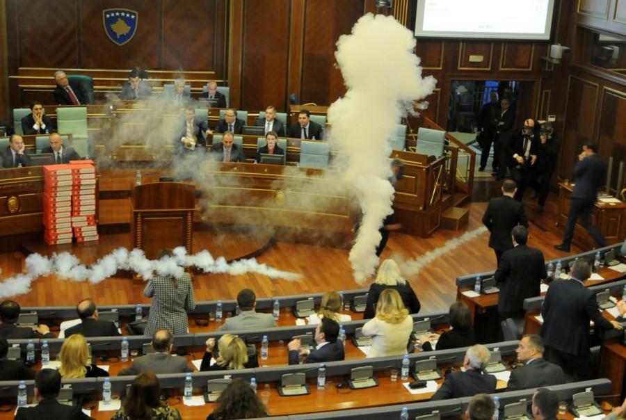 Opposition lawmakers threw tear gas canisters into the chamber to block discussion and a vote, causing deputies to withdraw choking and spluttering. Kosovo,Kosovo protest,Kosovo opposition,Kosovo politicians,Pristina,Kosovo Parliament,Pristina Parliament,Parliament tear gas,tear gas in Parliament