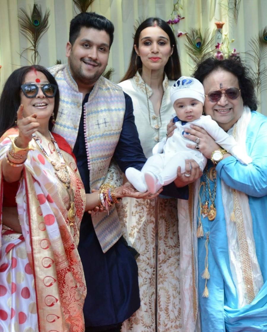 Music composer Bappi Lahiri along with his wife Chitrani, son Bappa Lahiri and daughter-in-law Tanisha during the rice ceremony (annaprasanna) of his grandson, in Mumbai. Jayaprada,Hemamalini,Neetu Chandra,Amar Singh,Randhir Kapoor,Bappi Lahiri,Bappi Lahiri grandson Annaprashan party,Krishh,Krishh Annaprashan party