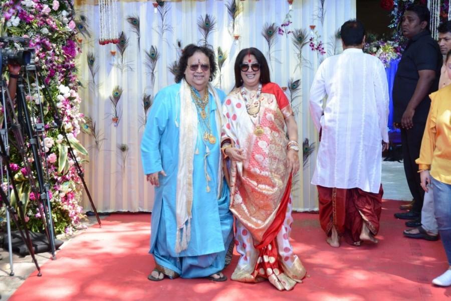 Music composer Bappi Lahiri along with his wife Chitrani during the rice ceremony (annaprasanna) of their grandson, in Mumbai. Jayaprada,Hemamalini,Neetu Chandra,Amar Singh,Randhir Kapoor,Bappi Lahiri,Bappi Lahiri grandson Annaprashan party,Krishh,Krishh Annaprashan party