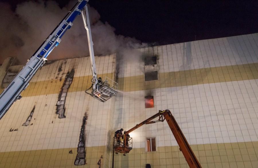 Members of the Emergency Situations Ministry work to extinguish a fire in a shopping mall in the Siberian city of Kemerovo, Russia. Russian shopping mall,fire at Russian shopping mall,Soviet Union,deadliest fires,shopping mall fire