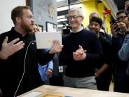 Tim Cook, Chief Executive Officer of Apple Inc., looks at a iPad, as he tours a technology lab, at an education-focused event at Lane Technical College Prep High School in Chicago, Illinois, U.S.