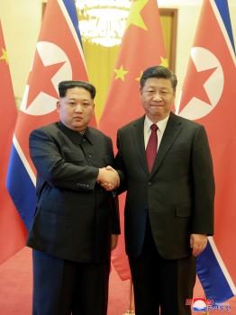 North Korean leader Kim Jong Un shakes hands with Chinese President Xi Jinping as he paid an unofficial visit to Beijing, China, in this undated photo released by North Korea's Korean Central News Agency (KCNA) in Pyongyang March 28, 2018.