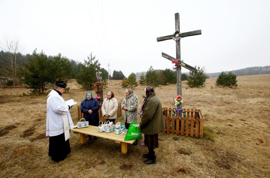 A Catholic priest conducts a service on the eve of Easter Sunday in the village of Zhykhi, Belarus. Christians,Easter,Easter 2018,Easter celebration,Easter celebration pics,Easter celebration images,Easter around the world,Easter celebration around the world