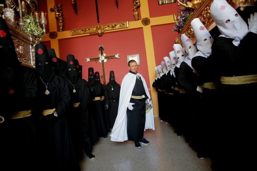 Penitents of "Santo Entierro" brotherhood carry floats bearing the statue of Jesus Christ (R) and the Virgin (L), inside their brotherhood house, after the governing body of the brotherhood decided that penance could not be carried out in the streets due to rain, during Holy Week in Ronda, near Malaga, southern Spain. Christians,Easter,Easter 2018,Easter celebration,Easter celebration pics,Easter celebration images,Easter around the world,Easter celebration around the world
