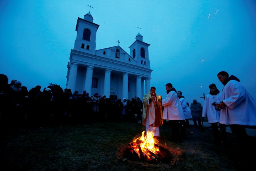 A Catholic priest conducts a service on Easter Eve in the village of Ragotna, Belarus. Christians,Easter,Easter 2018,Easter celebration,Easter celebration pics,Easter celebration images,Easter around the world,Easter celebration around the world