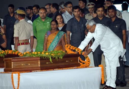 Bihar Chief Minister Nitish Kumar pays tribute to the Indian men killed by the Islamic State in Iraq's Mosul in 2014 after their mortal remains arrived in Patna on April 2, 2018.