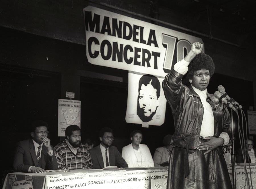 Winnie Mandela raises her fist in a black power salute after announcing that a massive pop concert will be held to mark the 70th birthday of her husband, jailed black nationalist leader Nelson Mandela on July 17, 1988. Winnie Mandela,Winnie Mandela dead,Winnie Mandela passed away,Winnie Madikizela-Mandela,Nelson Mandela,Anti-apartheid campaigner