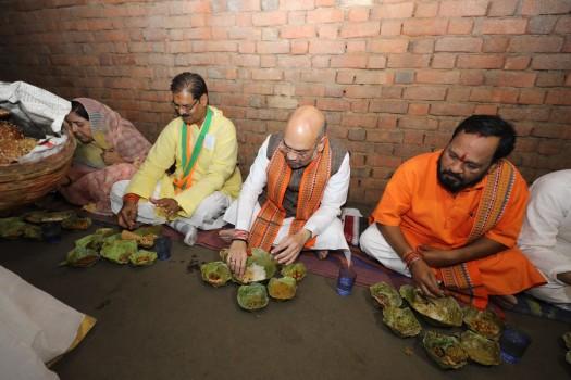 BJP President Amit Shah haves lunch at the Dalit daily wager's house in Deogaon village at Kendujhar District of Odisha on April 5, 2018. Also seen BJP Odisha president Basanta Panda.
