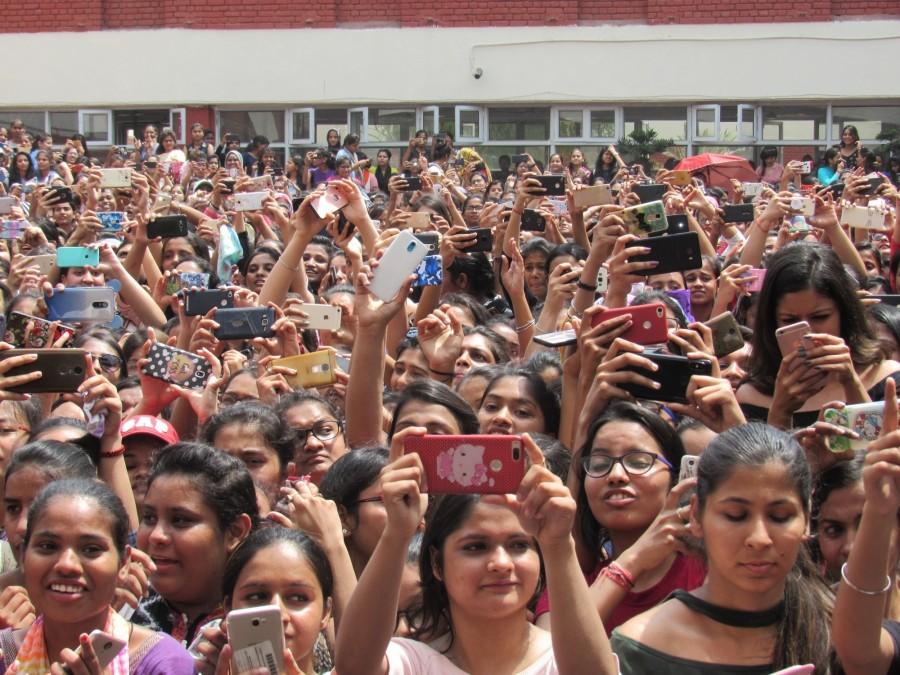 Students click photos during actor Varun Dhawan's visit to Lakshmibai College for the promotions of his upcoming film "October" in New Delhi on April 5, 2018. Varun Dhawan,actor Varun Dhawan,Varun Dhawan promotes October,October,October movie,October movie promotion,October movie promotion pics,October movie promotion images