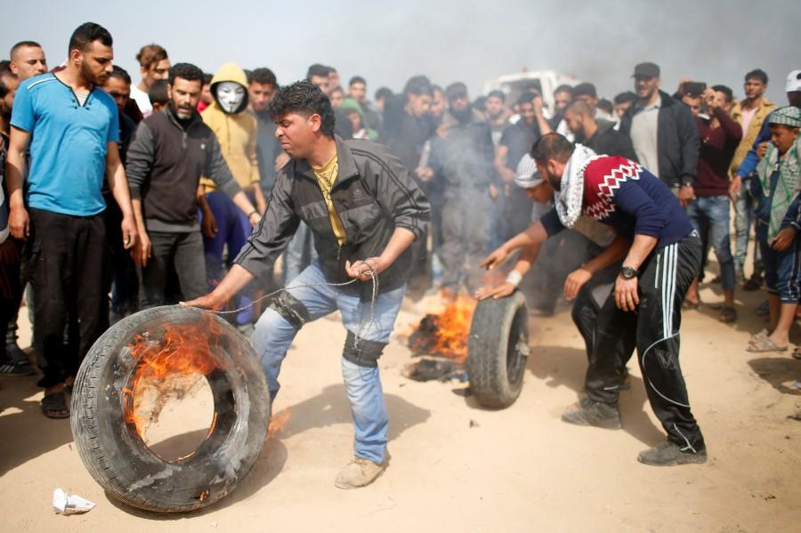 Palestinians burn tyres at the Israel-Gaza border during a protest demanding the right to return to their homeland, east of Gaza City April 6, 2018. Gaza-Israel border,Israeli troops,Palestinian protesters,Gaza border
