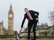 The world's shortest man Chandra Bahadur Dangi greets the tallest living man Sultan Kosen to mark the Guinness World Records Day in London November 13, 2014. Kosen measuring 251cm, towers over Dangi who is only 54.6cm tall. The Guinness World Records celebrates its 60th edition of the annual records book.
