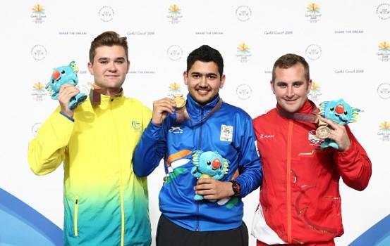 Silver medalist Sergei Evglevski of Australia, gold medalist Anish of India and bronze medalist Sam Gowin of England pose during the medal ceremony for the 25m Rapid Fire Pistol Men's Finals during the Shooting on day nine of the Gold Coast 2018 Commonwealth Games at Belmont Shooting Centre on April 13, 2018 on the Brisbane, Australia.