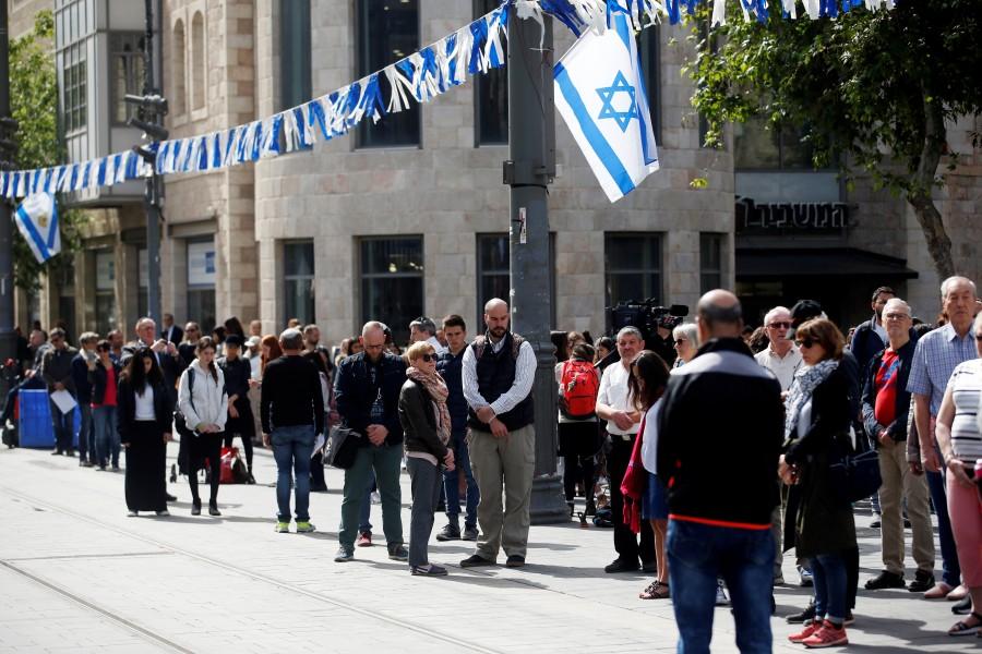 People stand still as a two-minute siren marking the annual Israeli Holocaust Remembrance Day is heard in Jerusalem, April 12, 2018. Holocaust Remembrance Day,Remembrance Day,Holocaust Remembrance Day pics,Holocaust Remembrance Day images,Israel stands silent