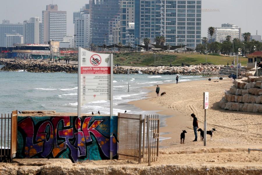Beachgoers stand still as a two-minute siren marking the annual Israeli Holocaust Remembrance Day is heard in Tel Aviv, Israel, April 12, 2018. Holocaust Remembrance Day,Remembrance Day,Holocaust Remembrance Day pics,Holocaust Remembrance Day images,Israel stands silent