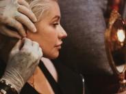 American singer-songwriter Christina Aguilera went for a make-up free look, proudly flaunting her freckles, as she was getting a new piercing. The "Beautiful" singer, 37, shared a series of make-up free photographs of herself getting a new ear piercings on her social media accounts.