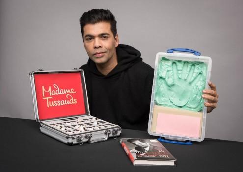 Filmmaker Karan Johar says he feels honoured to be the first filmmaker from India to have a wax statue at the Madame Tussauds. Karan on Thursday tweeted a photograph of himself, holding a briefcase in one hand and a wax imprint of his palm on the other hand. A copy of his biography 