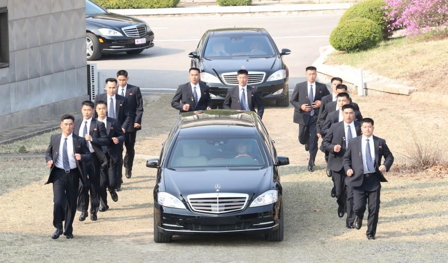Security personnel accompany a vehicle transporting North Korean leader Kim Jong Un at the truce village of Panmunjom inside the demilitarized zone separating the two Koreas, South Korea, April 27, 2018. North Korea leader Kim Jong Un,Kim Jong Un,Kim Jong Un with President Moon Jae-in,President Moon Jae-in,Moon Jae-in,Kim Jong Un and Moon Jae-in,Korea summit