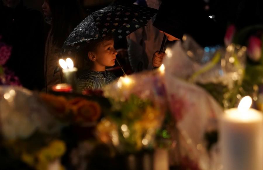 A child attends a candlelit vigil at the makeshift memorial a day after a van struck multiple people along a major intersection in north Toronto, Ontario, Canada, April 24, 2018. Toronto van attack,Toronto van attack mourn,mass killing,Toronto sidewalk