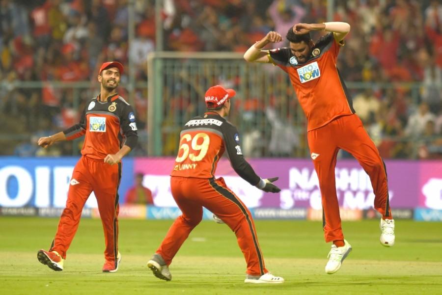 The Mumbai bowlers pulled out all stops to keep the star-studded Bangalore batting line-up at a manageable total. Put into bat, Bangalore started on a cautious note as openers Manan Vohra and de Kock added 38 runs for the opening wicket in five overs. Pacer Mitchell McClenaghan drew the first blood for Mumbai as he dismissed de Kock (7) in the fifth over. With the addition of another 23 runs in Bangalore's scorecard, an in-form Vohra (45 off 31) was trapped leg before off a Mayank Markande delivery in the ninth over. Incoming batter and skipper Virat Kohli (32 off 26) then joined Brendon McCullum and the duo showed some resistance forging a 60-run partnership to take Bangalore past the 100-run mark. Royal Challengers Bangalore beat Mumbai Indians,RCB beat MI,Virat Kohli,Indian Premier League,Indian Premier League 2018,Indian Premier League pics,Indian Premier League images,IPL pics,IPL images,IPL stills